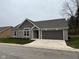 One-story home with stone and brown siding, two-car garage, and landscaped lawn at 4204 W Palomino Ct, Muncie, IN 47304