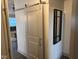 Bright hallway with barn door and mirror at 4204 W Palomino Ct, Muncie, IN 47304