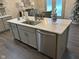 Large kitchen island with quartz countertop, sink, and dishwasher at 4204 W Palomino Ct, Muncie, IN 47304