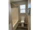 Clean bathroom with tub, toilet, and window for natural light at 7530 Redcliff Rd, Indianapolis, IN 46256