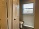Small bathroom with a toilet and window at 7530 Redcliff Rd, Indianapolis, IN 46256