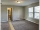 Spacious bedroom with neutral walls, plush carpeting, and ensuite bathroom at 7530 Redcliff Rd, Indianapolis, IN 46256