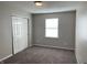 Spacious bedroom with neutral walls, plush carpeting, and double doors closet at 7530 Redcliff Rd, Indianapolis, IN 46256
