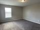 Well-lit bedroom with neutral walls and plush carpeting at 7530 Redcliff Rd, Indianapolis, IN 46256