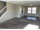 Living room with gray carpeting, vinyl flooring, and a staircase at 7530 Redcliff Rd, Indianapolis, IN 46256