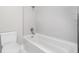 Clean bathroom with a bathtub and white tile at 1423 Hoyt Ave, Indianapolis, IN 46203