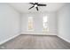 Well-lit bedroom with gray carpeting and two large windows at 1423 Hoyt Ave, Indianapolis, IN 46203