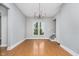 Dining room with hardwood floors, chandelier, and staircase at 1423 Hoyt Ave, Indianapolis, IN 46203