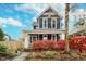 Charming two-story home with a gray exterior and red landscaping at 1423 Hoyt Ave, Indianapolis, IN 46203
