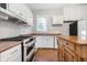 Newly renovated kitchen with white cabinets and a large wood center island at 1423 Hoyt Ave, Indianapolis, IN 46203