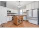 Updated kitchen boasts white cabinets, stainless steel appliances, and a wood center island at 1423 Hoyt Ave, Indianapolis, IN 46203