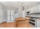 Bright kitchen featuring wood island, white cabinetry, and new appliances at 1423 Hoyt Ave, Indianapolis, IN 46203