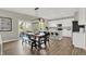 Open dining area with a rustic table, bench seating, and kitchen access at 1829 Grand Vista Blvd, Greenwood, IN 46143