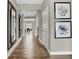 Long hallway with wood-look floors and stylish wall art at 1829 Grand Vista Blvd, Greenwood, IN 46143