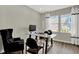 Home office with glass desk, comfortable chair, and natural light at 1829 Grand Vista Blvd, Greenwood, IN 46143