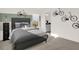 Spacious bedroom with a gray bed, a dresser, and wall-mounted bikes at 1895 Grand Vista Blvd, Greenwood, IN 46143