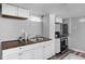 Efficient basement kitchenette with white cabinets, wood countertops, and modern appliances at 5114 Hillside Ave, Indianapolis, IN 46205