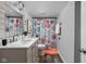 Clean bathroom with updated vanity, stylish shower curtain, and dark flooring at 5114 Hillside Ave, Indianapolis, IN 46205