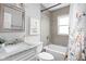 Bathroom with bathtub, shower, and floral curtain at 5114 Hillside Ave, Indianapolis, IN 46205