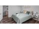 Bright bedroom with a queen bed, neutral tones, and access to a bathroom at 5114 Hillside Ave, Indianapolis, IN 46205