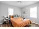 Bright bedroom with orange bedding and wood floors at 5114 Hillside Ave, Indianapolis, IN 46205