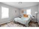Bedroom with green bedding and patterned rug at 5114 Hillside Ave, Indianapolis, IN 46205