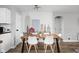 Dining area with a wooden table, white chairs, and a city skyline mural at 5114 Hillside Ave, Indianapolis, IN 46205