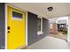 Yellow front door with glass accents and black hardware at 5114 Hillside Ave, Indianapolis, IN 46205