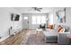 Living room with gray sectional sofa, hardwood floors, and a white media console at 5114 Hillside Ave, Indianapolis, IN 46205