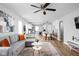Open concept living and dining area with gray sectional and city mural at 5114 Hillside Ave, Indianapolis, IN 46205