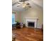 Living area featuring a fireplace, hardwood floors, and plenty of natural light at 636 Creston Point Cir, Indianapolis, IN 46239