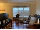 Living room with wood floor, large window, and classic chairs at 636 Creston Point Cir, Indianapolis, IN 46239