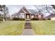 Brick ranch home with a spacious lawn and walkway at 9699 Prairiewood Way, Carmel, IN 46032