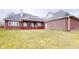 Brick house with backyard patio and grassy area at 9699 Prairiewood Way, Carmel, IN 46032