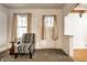 Living room with patterned chair and access to front porch at 1708 S Randolph St, Indianapolis, IN 46203