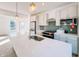 Modern kitchen with white cabinets, quartz countertops, and a green tile backsplash at 2151 N College Ave, Indianapolis, IN 46202