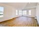 Spacious living room with large windows and wood-look flooring at 2151 N College Ave, Indianapolis, IN 46202