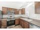 Modern kitchen with stainless steel appliances and wood cabinets at 3194 Monterey Dr, Whiteland, IN 46184