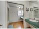 Bathroom with a teal vanity and cork flooring at 6951 Lancet Ln, Indianapolis, IN 46220