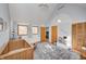 Bedroom with vaulted ceiling, crib, dresser, and reading nook at 6951 Lancet Ln, Indianapolis, IN 46220