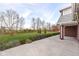 Landscaped backyard with large grassy area and patio at 11736 Grazing Ln, Indianapolis, IN 46239