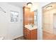 Bathroom with wood vanity, large mirror, and walk-in closet at 11736 Grazing Ln, Indianapolis, IN 46239