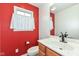 Small bathroom with red accent wall and updated vanity at 11736 Grazing Ln, Indianapolis, IN 46239