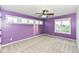Spacious bedroom with neutral carpeting, ceiling fan, and multiple windows at 11736 Grazing Ln, Indianapolis, IN 46239