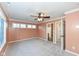 Bedroom with carpet, ensuite bathroom access, and a ceiling fan at 11736 Grazing Ln, Indianapolis, IN 46239