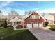 Brick home with two-car garage and landscaped lawn at 11736 Grazing Ln, Indianapolis, IN 46239