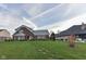 Brick ranch home with a large grassy yard and mature trees at 11736 Grazing Ln, Indianapolis, IN 46239