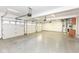 Spacious three-car garage with epoxy floors and storage at 11736 Grazing Ln, Indianapolis, IN 46239