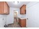 Laundry room with wood cabinets and access to the backyard at 11736 Grazing Ln, Indianapolis, IN 46239