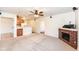 Living room with a brick fireplace and kitchen with breakfast bar at 11736 Grazing Ln, Indianapolis, IN 46239